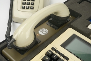 Telephone handset placed in the acoustic coupler