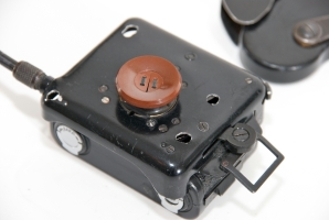Close-up of the button that conceals the lens. Note the split at the centre of the button.