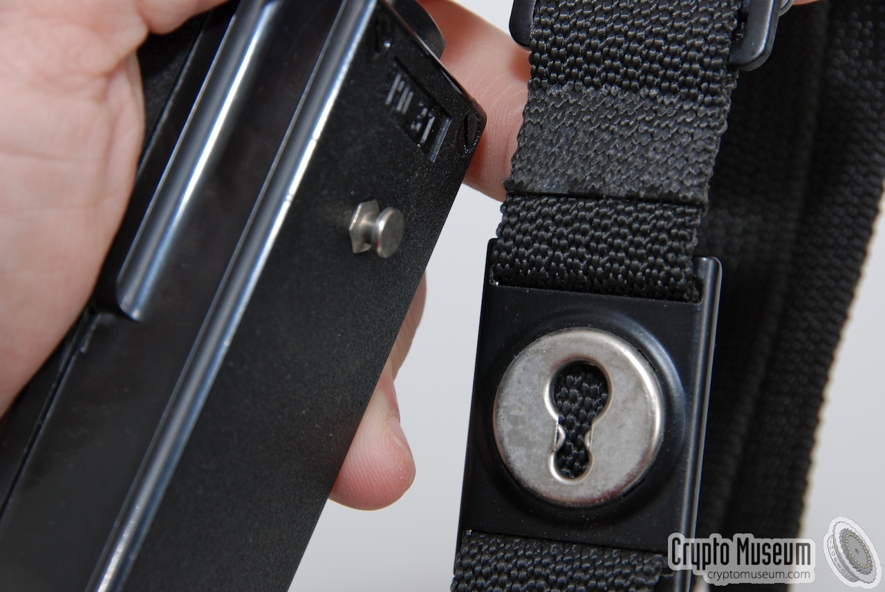 How to clip the microphone to the shoulder strap, using the special slot.