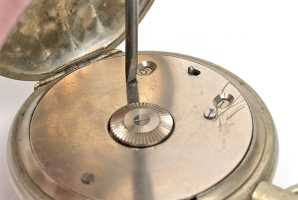 Using a modified screwdriver to remove the screws at the rear