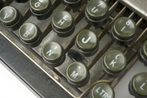 Close-up of the keyboard with the indicator lamp visible just above the letter 'M'