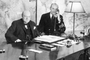 Churchill in the Cabinet War Rooms during WWII, with a staff member operating his Scrambler Phone. Copyright IWM [4]. Click to enlarge.