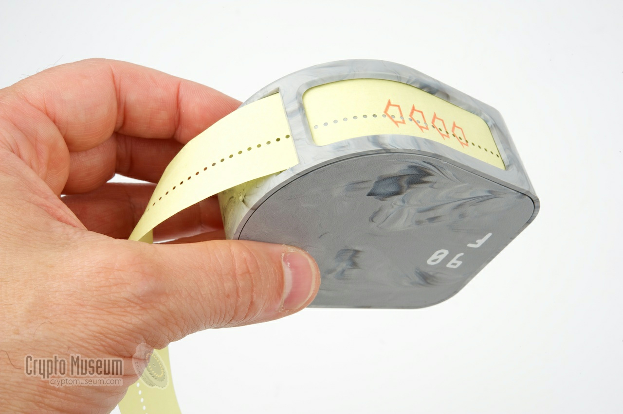 A canister holding a punched paper tape with the key variables