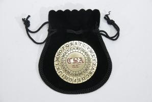 A replica of the Confederate Cipher Disc on top of its leather bag.