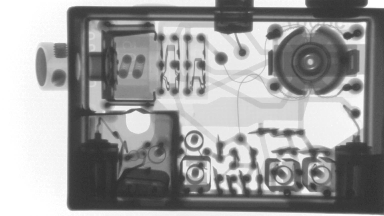 X-ray of a large plug-in showing a crystal inside a shielded compartment at the bottom left.